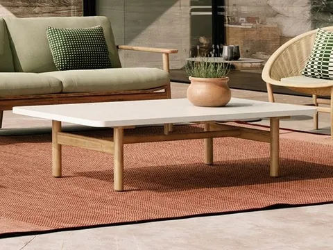 Kettal Riva teak patio furniture in a garden, catalog photograph